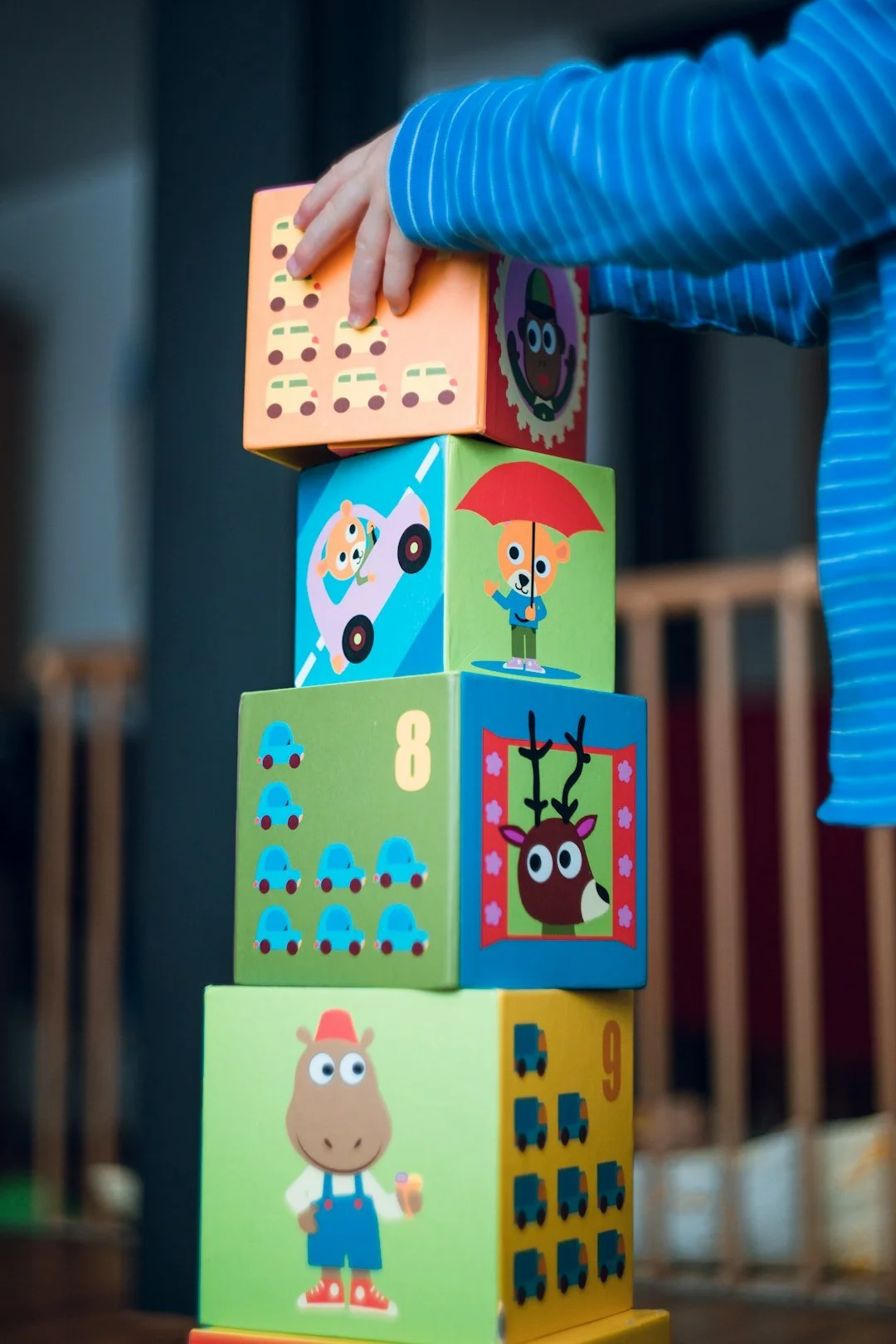 Child stacking colorful blocks